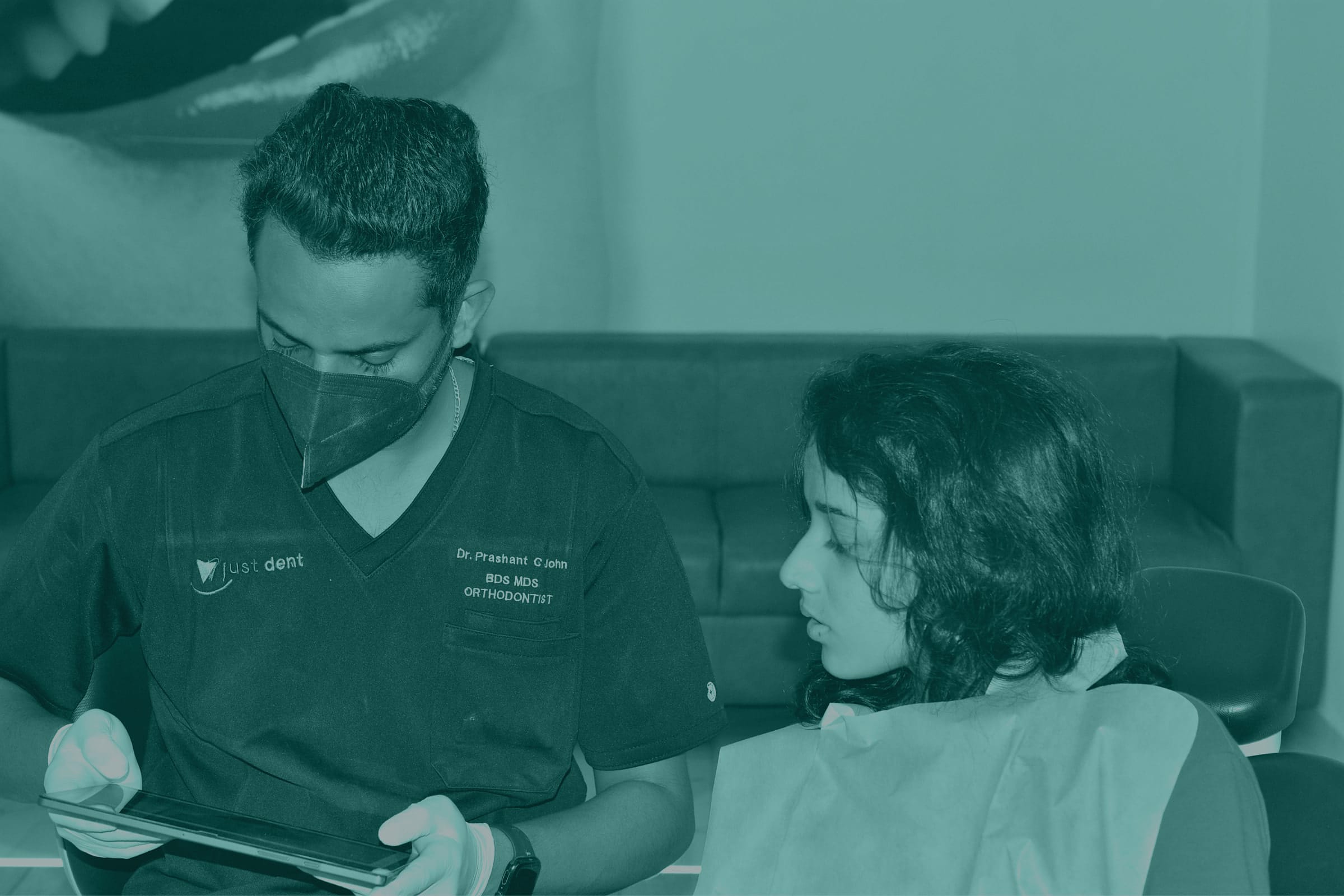 Dentist consulting with a patient at Just Dent